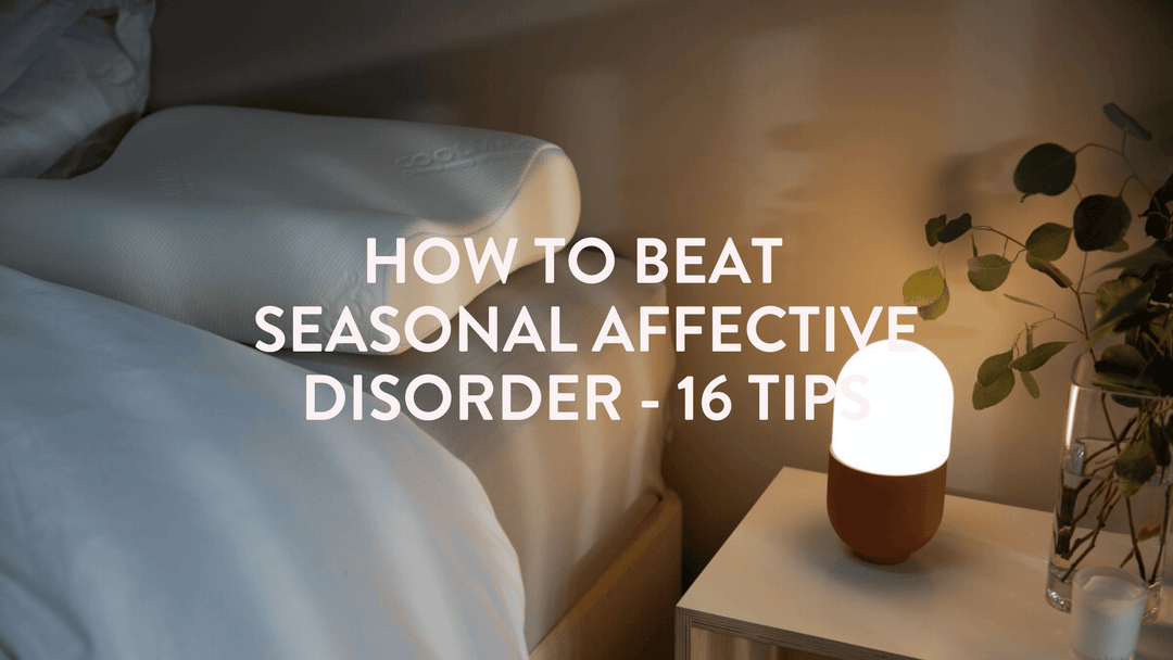 a quiet scene of a bed, pillow and seasonal affective disorder SAD lamp on the bedside table 