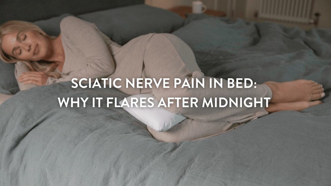 Person sleeping on their side in a large double bed witha Putnams butterfly pillow between their knees 