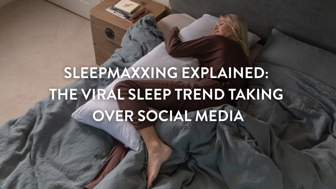 Person sleeping in a large double bed using Putnams pillows 