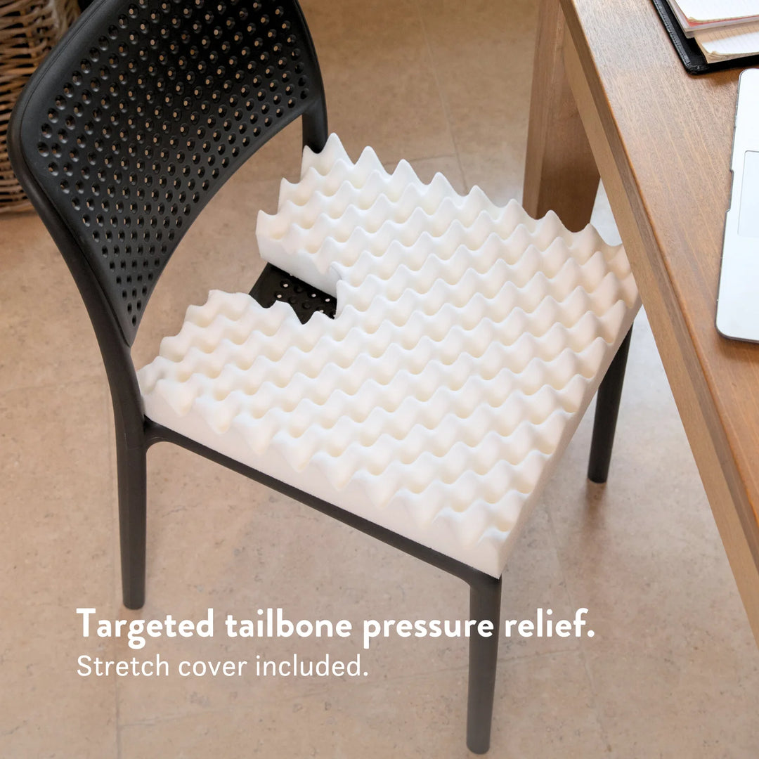 Tailbone Pain Cushion with a cut out for pressure relief at the back of the cushion. Stretch navy blue or black cover available in different sizes. High density foam with a 2 year guarantee.