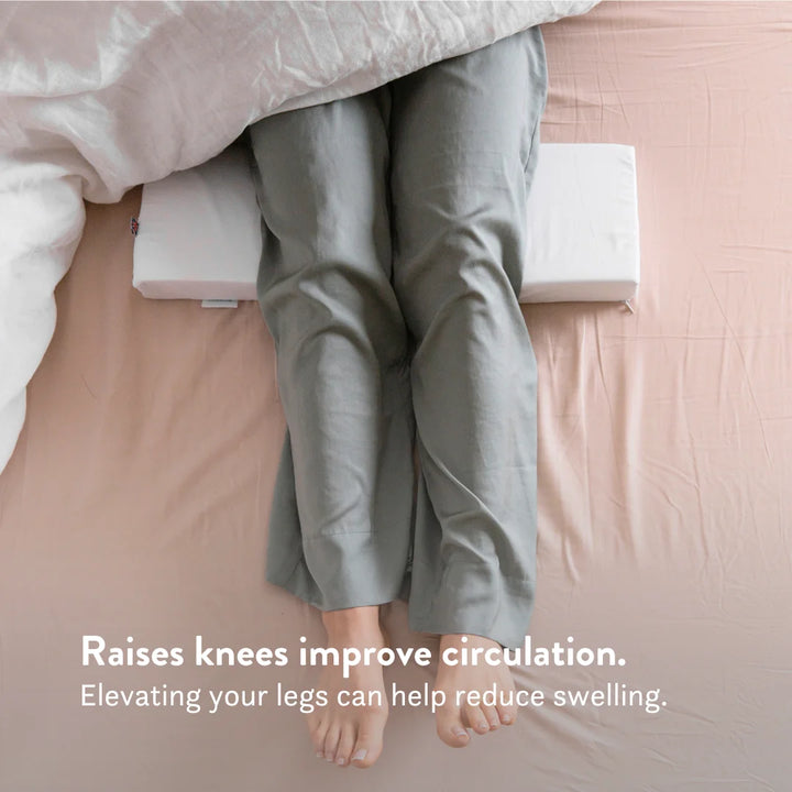 Knee raiser pillow. heel leg lift pillow to reduce pressure on heels sores bed triangle small putnams uk Cushion to lift heels off the bed to reduce pressure build up (formation of pressure sores, ulcers, & decubitus). Fitted, removable, washable cover. Handmade in the UK.